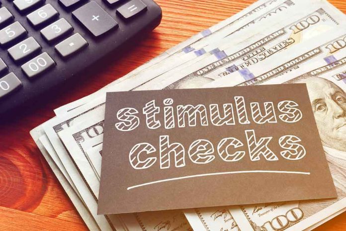 shutterstock_1704201565 stimulus checks note on cash with calculator