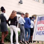 voters standing in line outside a polling place
