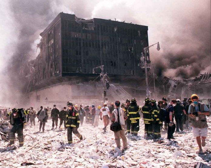 Emergency responders and civilians amidst debris at a disaster site