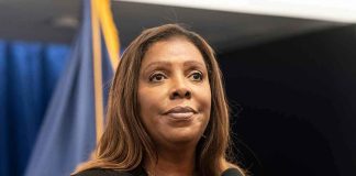 Woman speaking at a press conference microphone