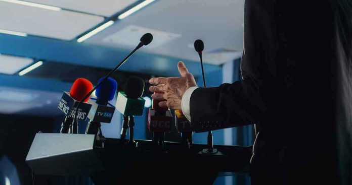 Speaker at podium with multiple microphones