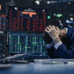 Tech Bro Loses $30B After Two $5B Bets Blew Up Trader stressed out by multiple declining stock charts.