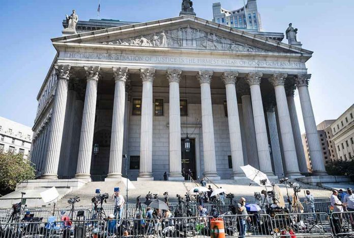 2445868619-1 Reporters and photographers gathered outside a neoclassical courthouse