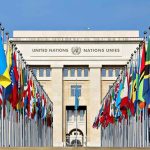 Cuba Walks Out Mid-Trump UN Speech United Nations building with numerous national flags outside.