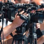 A Famous Name Is Not a Mere Symbol in a Short-Deadline Primary television cameras on tripods at a media event