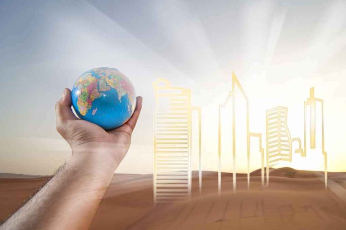 Hand holding a small globe in front of a glowing city skyline outline