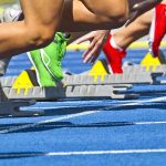 Track Meet Turns Deadly — Self-Defense Fight Erupts Athletes starting a sprint from starting blocks on a blue track