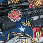 Loaded Mag At Trump Course Sparks Raid Rifles and pistol with ammunition on American flag