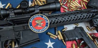 Rifles and pistol with ammunition on American flag