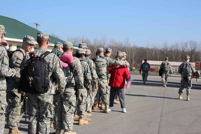 shutterstock_1055112833 Soldiers in uniform line up outdoors with gear