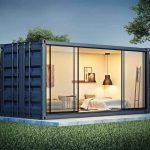 “$62M” Buys Three Apartments shipping container home with glass walls at dusk