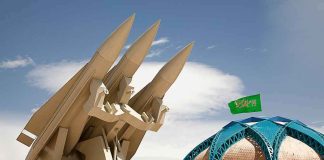 missile launcher beside domed building with green flag