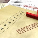 Classified documents with red Top Secret stamp and rubber stamp