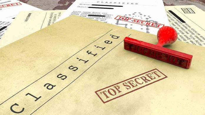 shutterstock_1099380299 Classified documents with red Top Secret stamp and rubber stamp