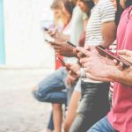 Holiday Chaos Erupts — Teen Mob Swarms Cops Group of people using smartphones while standing in a row