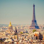 Pope Just Did Something Remarkable in Secular Paris A panoramic view of Paris featuring the Eiffel Tower and a golden dome