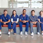 Group of medical professionals sitting on a bench
