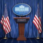 White House press podium with microphones and two American flags