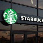 Starbucks Puts 250 Stores on the Chopping Block Starbucks store exterior with illuminated sign