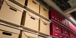 Shelves filled with brown and red storage boxes for organizing documents