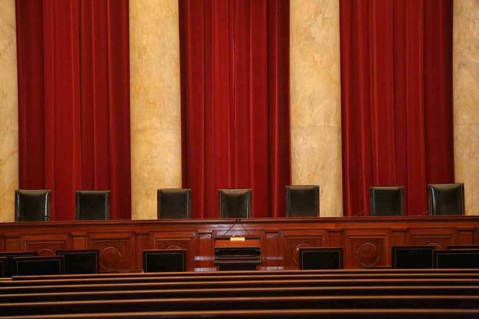 Empty courtroom bench with red curtains and leather chairs