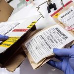 Bio Lab Shock: 113 Vials Found Gloved hands handling labeled evidence bags and boxes
