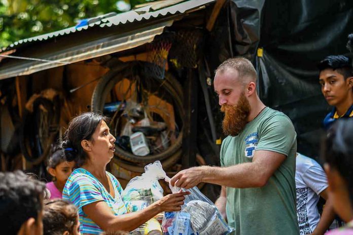 shutterstock_1413100481 Volunteers distribute relief supplies to a woman outdoors