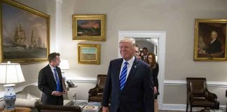 Donald Trump walks through an office with Sean Lawler nearby and Mariano Rajoy following behind