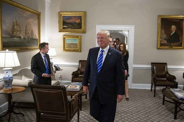 Donald Trump walks through an office with Sean Lawler nearby and Mariano Rajoy following behind