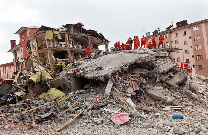 shutterstock_148947701 Rescue workers in orange uniforms on a collapsed building site after an earthquake