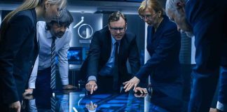 Business team reviews data on a large interactive table