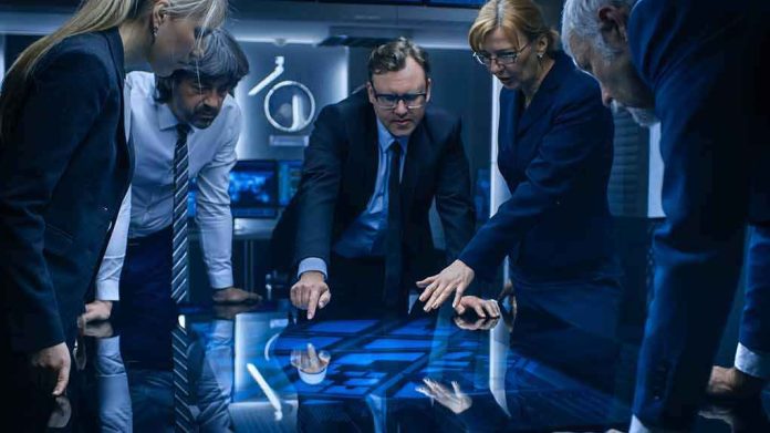 Business team reviews data on a large interactive table