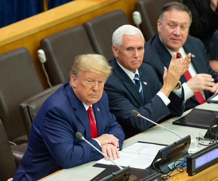 three men in suits seated at a conference table