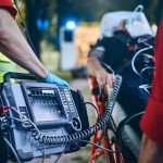 Burning Man Reports SECOND Death in Days Paramedic with defibrillator beside patient on stretcher