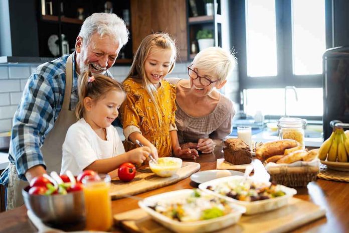 Grandparents and two children cooking together in a bright kitchen