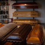 System Knew, 4 Kids Died Anyway Row of coffins displayed in a funeral home showroom