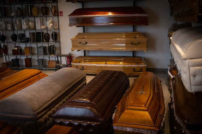 shutterstock_1562591803 Row of coffins displayed in a funeral home showroom