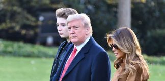 Donald Trump and Melania Trump walking outdoors with another person