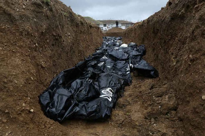 Body bags in a mass grave trench