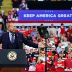 Communism Panic Becomes GOP Rocket Fuel Crowd at a political rally with a speaker at a podium; Stephen Paea, Curtis Lofton, Walter Jones, John Sullivan, and Colin David Jones present