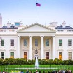 The White House facade with fountain and flag