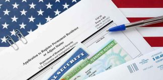 immigration forms with green card and social security card on US flag background
