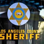 Los Angeles County Sheriff emblem on a glass door