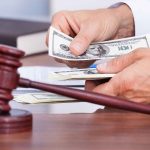 Court FORBIDS Trump From Using ONE Word A person counting cash in a courtroom setting with a gavel in the foreground