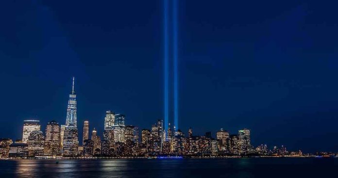 shutterstock_1742695205 City skyline at night with twin blue light beams rising into the sky