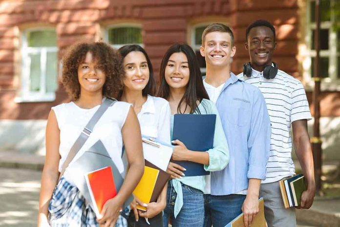 Group of students standing outdoors with notebooks