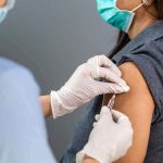 Healthcare worker administers vaccine to patient’s upper arm