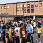 DOJ Targets Schools Over Parental Opt-Outs Students gathered outside a school building entrance