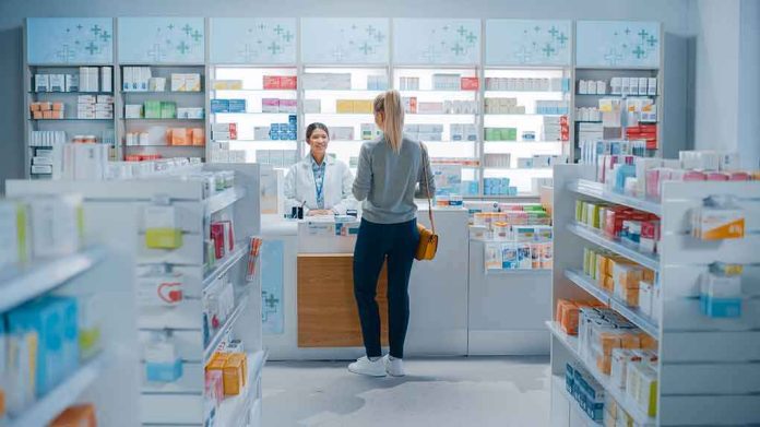 Yvonne Li assisting a customer at a pharmacy counter