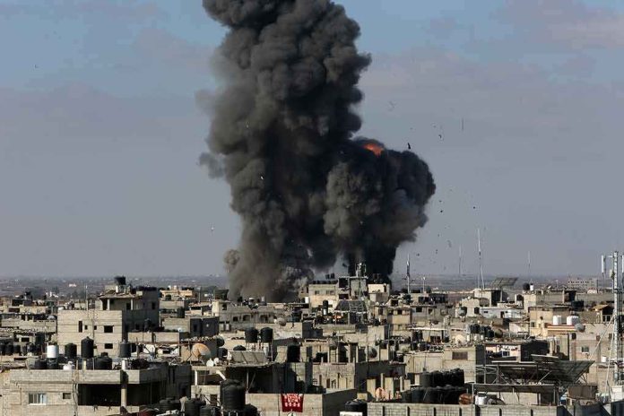 Thick black smoke rises from an explosion over a dense urban area